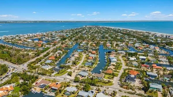 Birds eye view of property with a water view