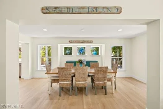 Dining room with recessed lighting, baseboards, and light wood-style flooring