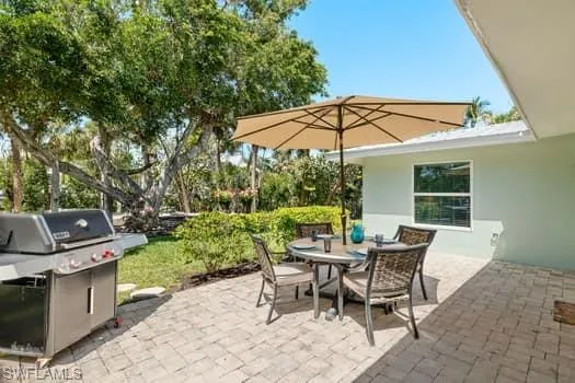 View of patio / terrace with a grill and outdoor dining area