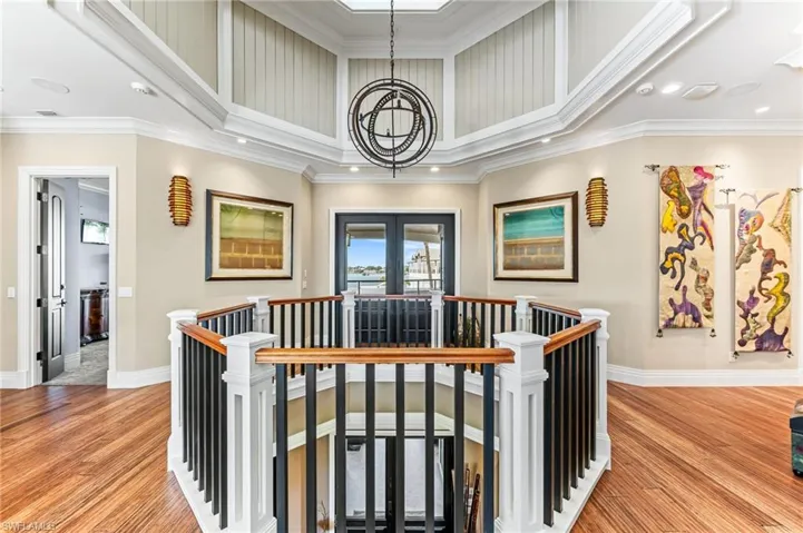 Corridor with an upstairs landing, a chandelier, recessed lighting, and crown molding