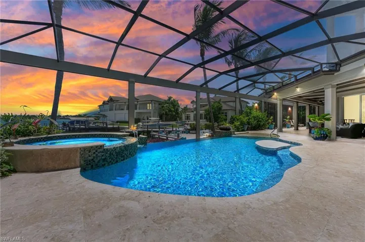 View of infinity pool with a pool with connected hot tub