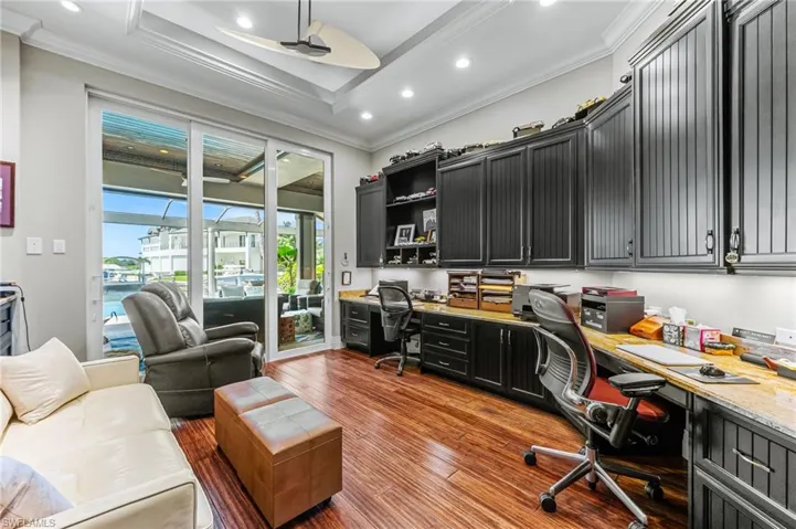 Home office with built in desk, ornamental molding, ceiling fan, and recessed lighting