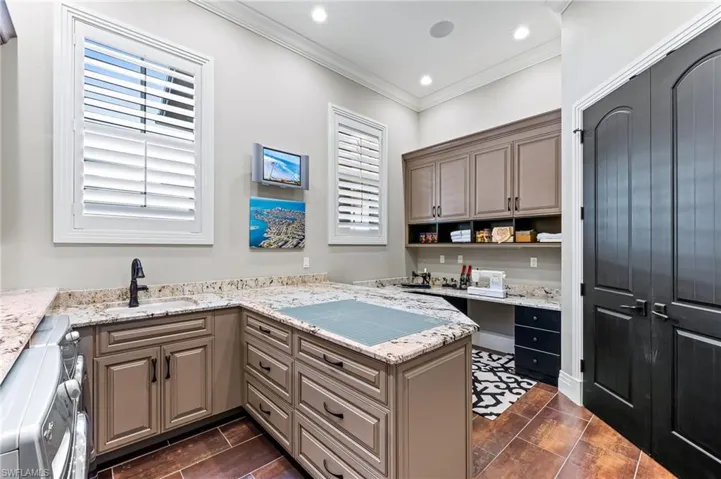 Laundry room with additional cabinetry and storage