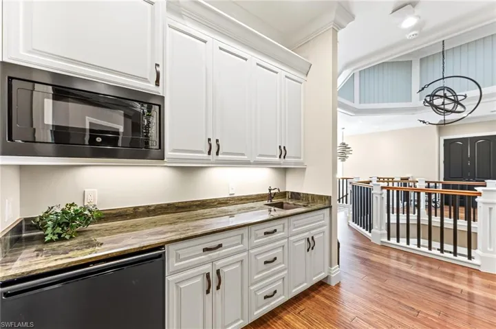 Upstairs kitchen with sink and microwave and refrigerator