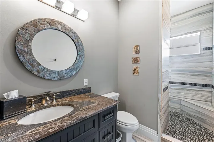 Guest Bathroom with tiled walk-in shower and vanity