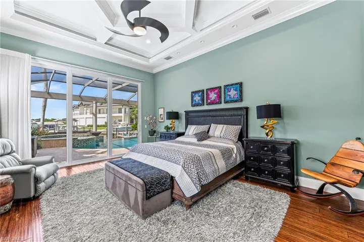 Master Bedroom featuring access to outside, coffered ceiling