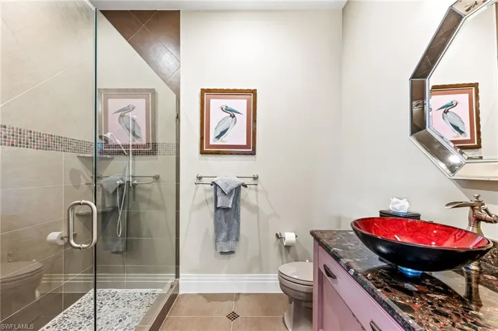 Guest Bathroom featuring a walk-in shower, and vanity