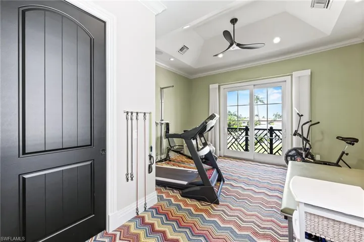 Workout room with ornamental molding, ceiling fan, recessed lighting, and carpet floors, balcony to front of home