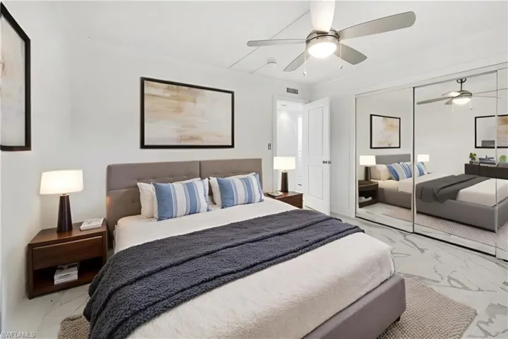 Virtually staged. Entire wall of closets with floor to ceiling mirrored doors