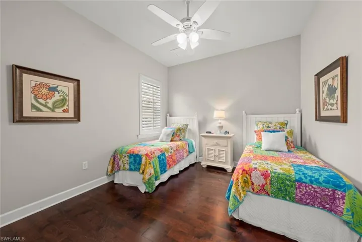 Bedroom featuring dark wood-type flooring and ceiling fan