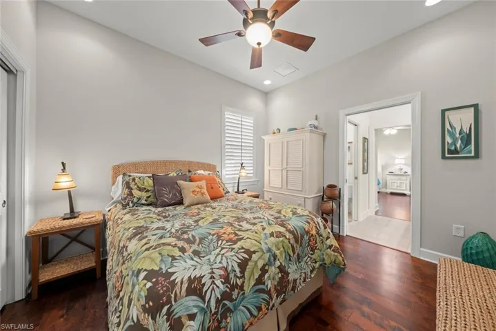 Bedroom featuring dark wood-type flooring, ceiling fan, and recessed lighting