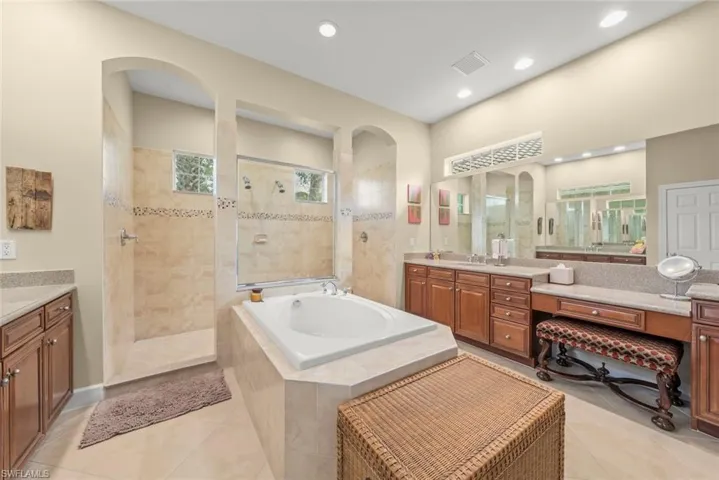 Bathroom with vanity, walk in shower, light tile patterned floors, a garden tub, and recessed lighting
