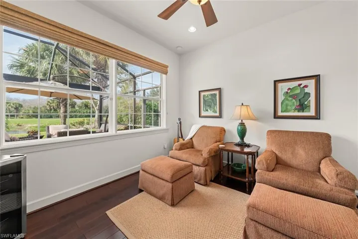 Den with dark wood finished floors, ceiling fan, and recessed lighting