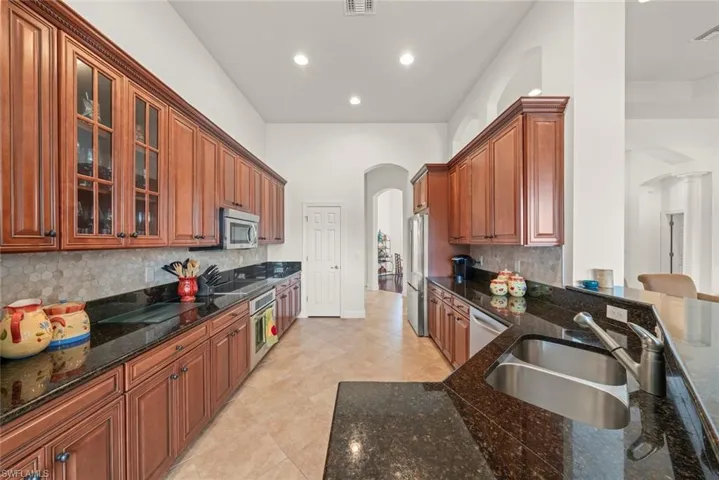 Kitchen new decorative backsplash, granite countertops, ample cabinets, and recessed lighting