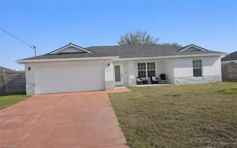 Single story home with stone siding, stucco siding, and driveway