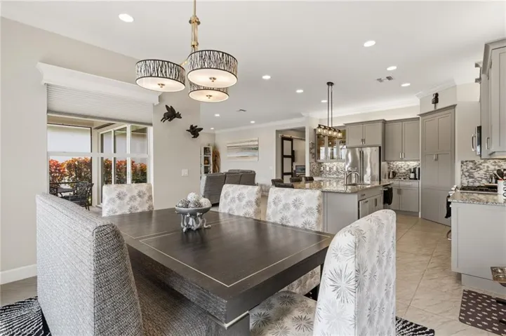Open area dining room with ease of access to kitchen, designer lighting.