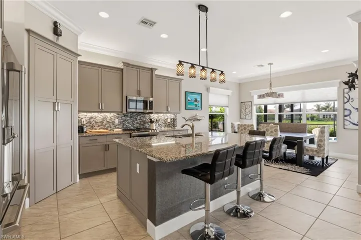 Open kitchen with island, plenty of seating and lots of cabinet space.