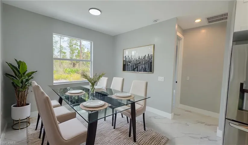Dining room featuring marble finish floor, recessed lighting, baseboards, and visible vents