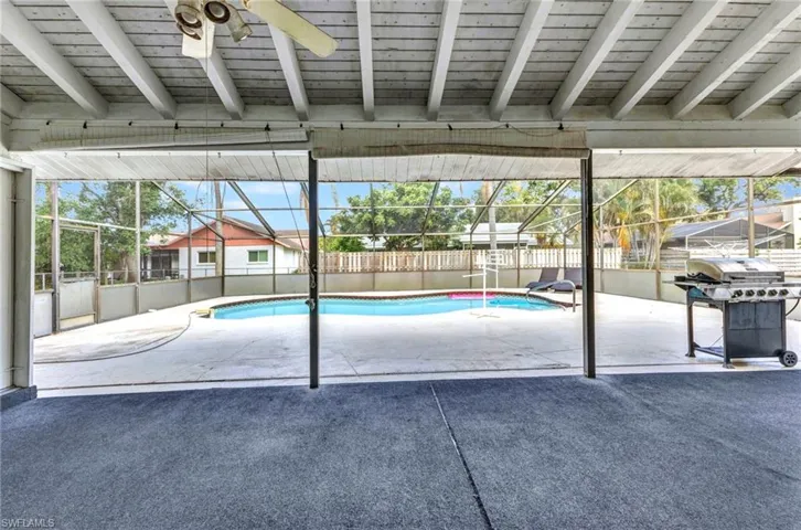 View of swimming pool with a grill, a fenced backyard, a patio, and a lanai
