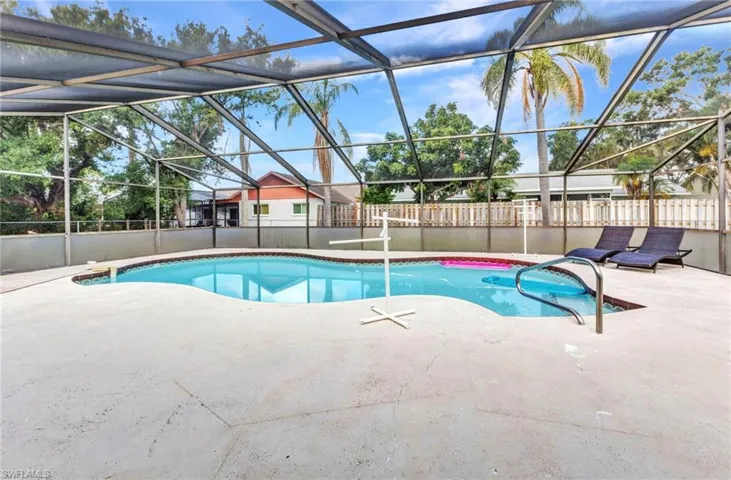 View of pool with a patio, a fenced backyard, and a lanai