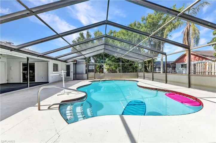 Swimming pool with a patio and a lanai