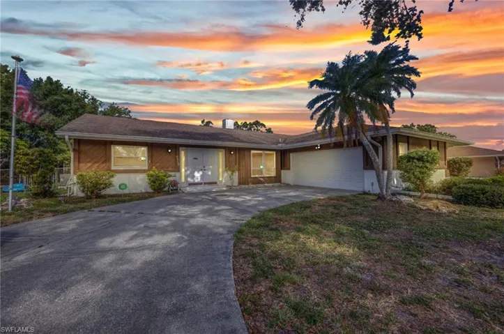 View of front of home featuring a garage and driveway