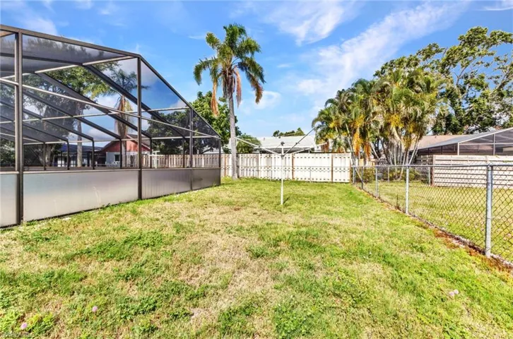 View of yard with glass enclosure