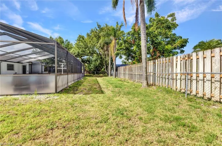 View of yard featuring glass enclosure