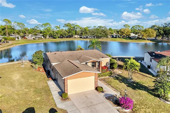 View from above of property featuring a large body of water and a tree filled landscape