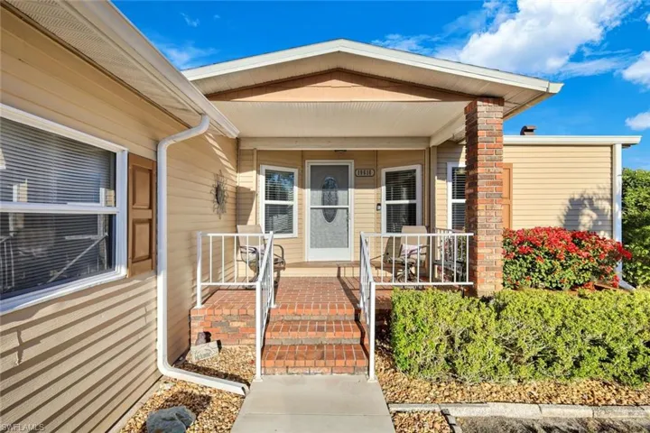 View of exterior entry featuring covered porch