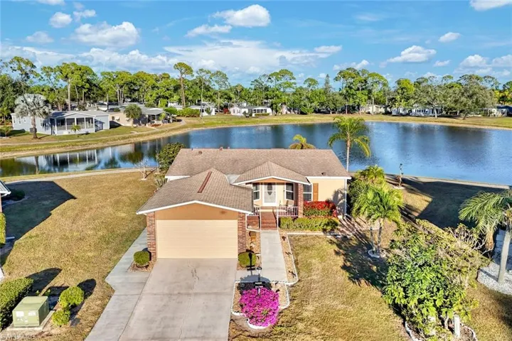 View from above of property featuring a large body of water and a tree filled landscape
