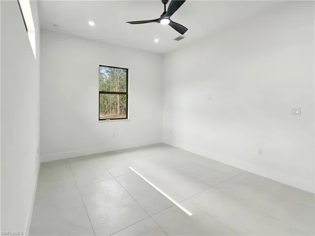 Unfurnished room with baseboards, light tile patterned floors, and recessed lighting