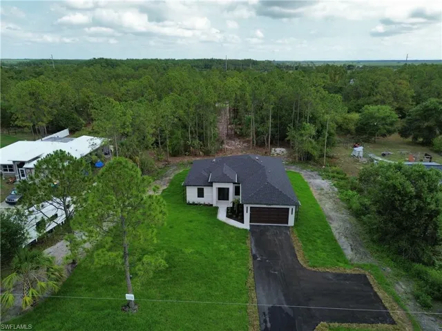 View of subject property featuring a forest