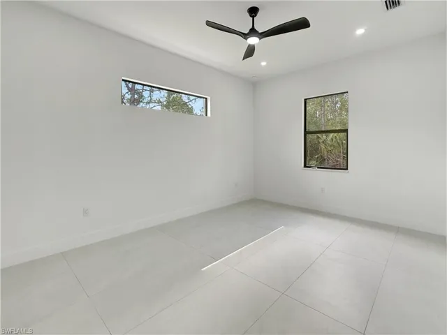 Spare room featuring plenty of natural light, recessed lighting, and baseboards