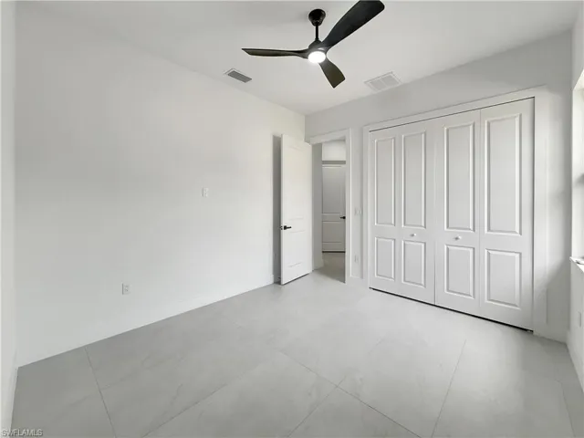 Unfurnished bedroom with a closet, ceiling fan, and baseboards