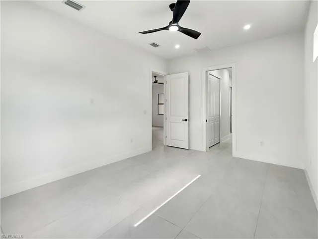 Unfurnished bedroom with baseboards, recessed lighting, light tile patterned flooring, and ceiling fan