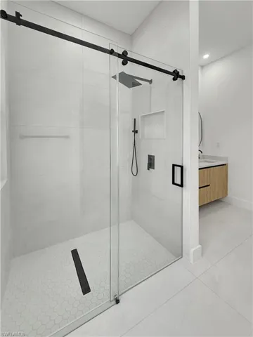 Full bath with a stall shower, tile patterned flooring, recessed lighting, and vanity