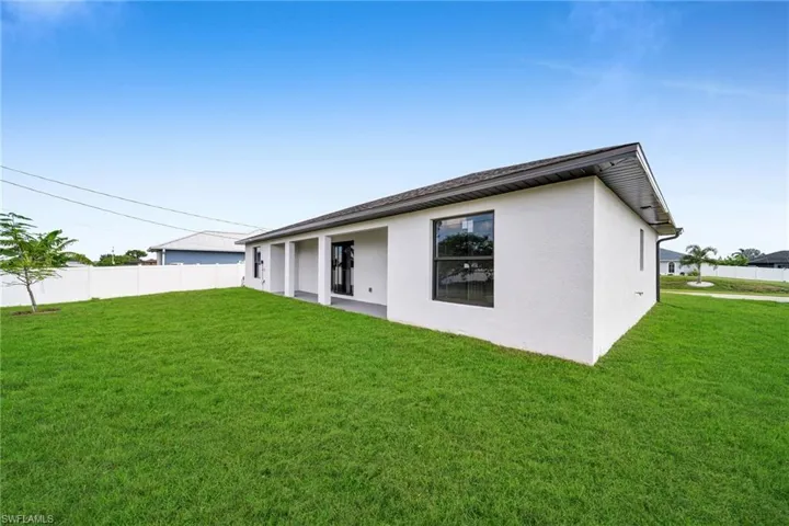 Rear view of property featuring stucco siding