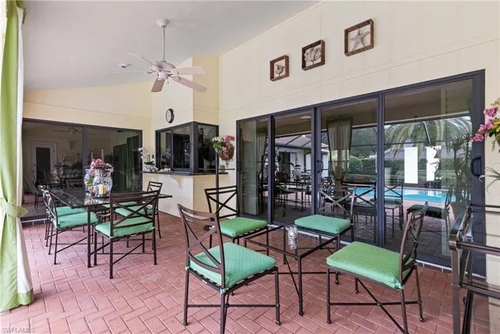 Enjoy al fresco dining under cover on the poolside lanai