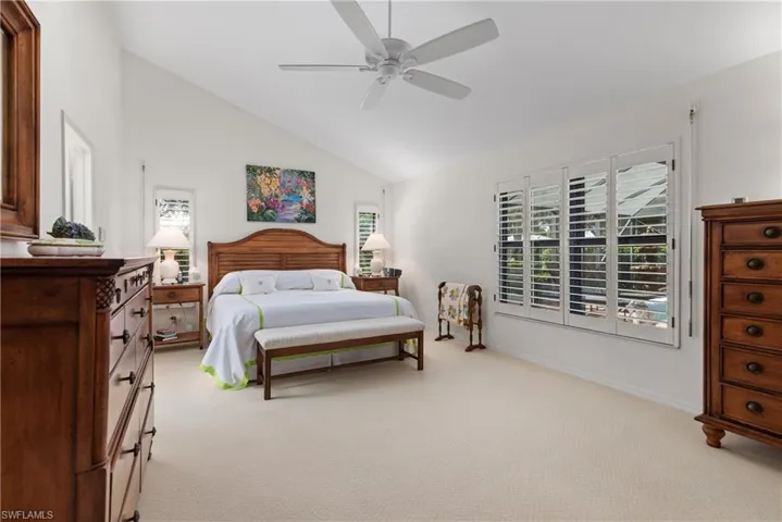 Spacious primary bedroom adjacent to dreamy bath and poolside lanai