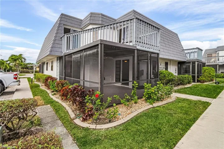 View of property exterior with a sunroom and a balcony