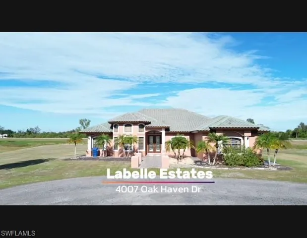 View of front of property with a front yard and french doors