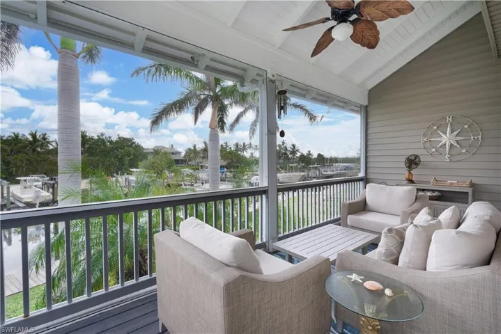 Screened in patio with an outdoor living space and ceiling fan