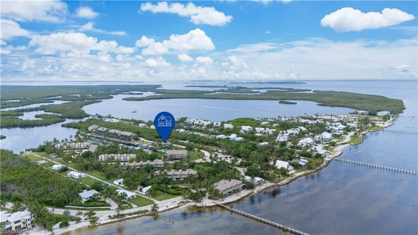 Aerial overview of property's location with a nearby body of water