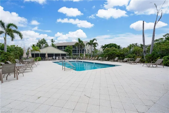 Community pool with a patio