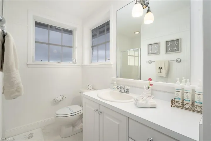 Full bath featuring vanity, a stall shower, and light tile patterned floors