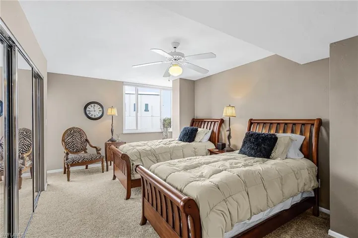 TWIN BEDS ADORN THE GUEST BEDROOM WHICH ALSO HAS ACCESS TO A SECOND SCREENED LANAI.