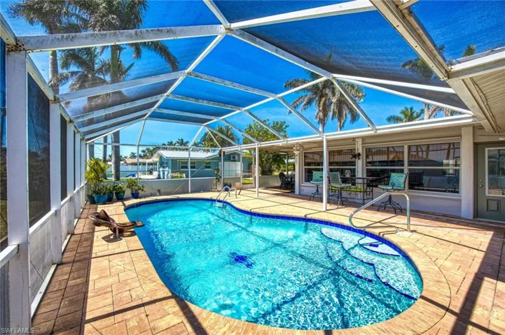 Outdoor pool with a patio and a lanai