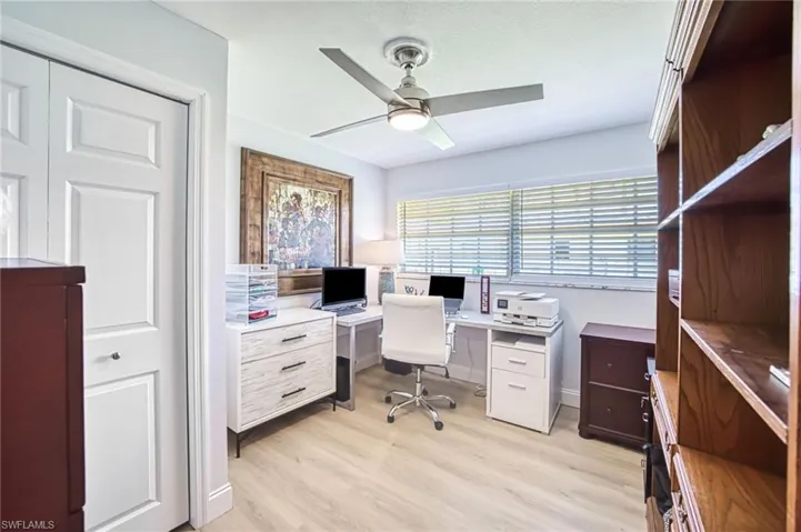 Office/bedroom area featuring light wood-type flooring