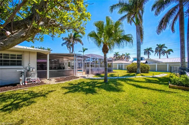 View of yard featuring a lanai and fence